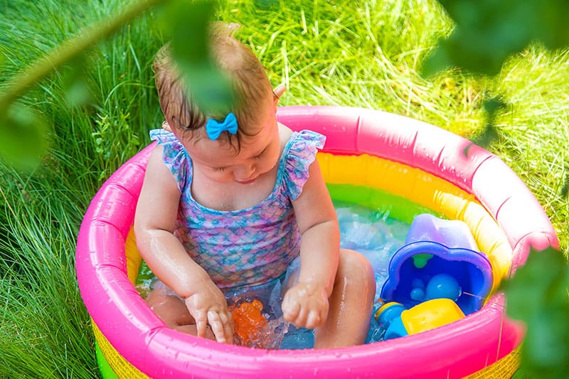 a small girl playing in the water