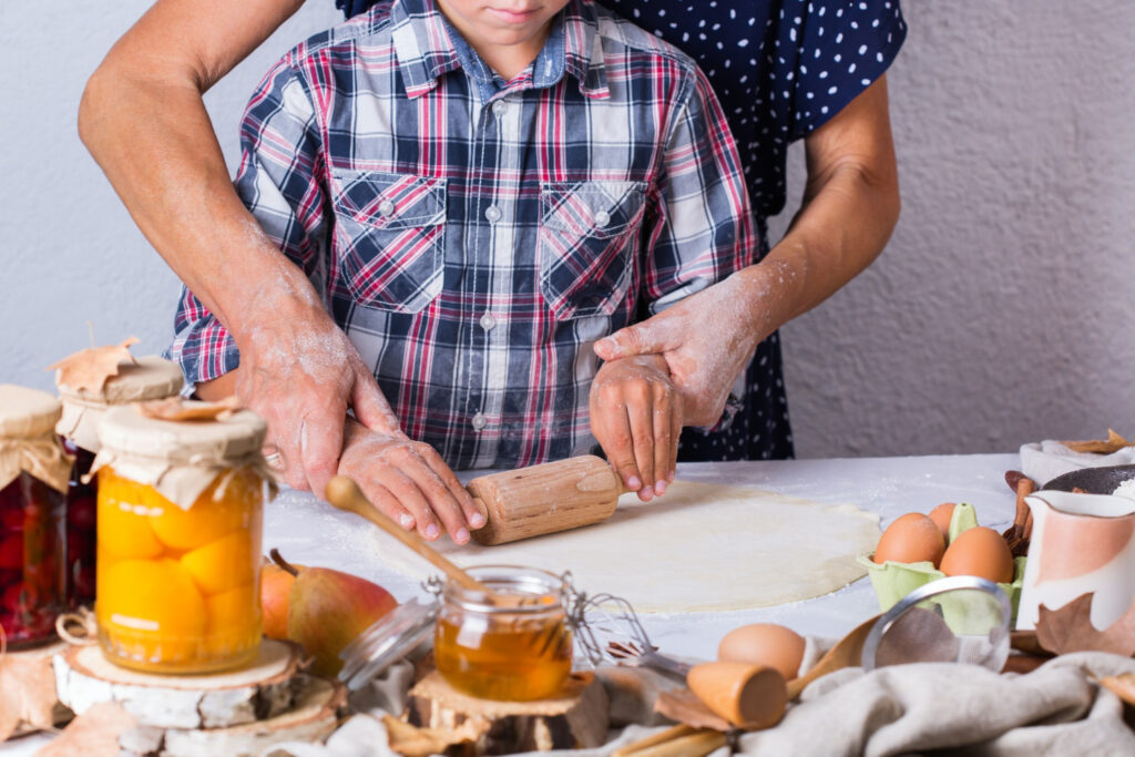 grandmother and young boy cooking together