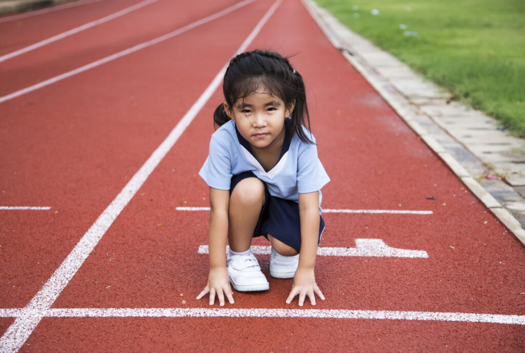 a small girl ready to start a sprint